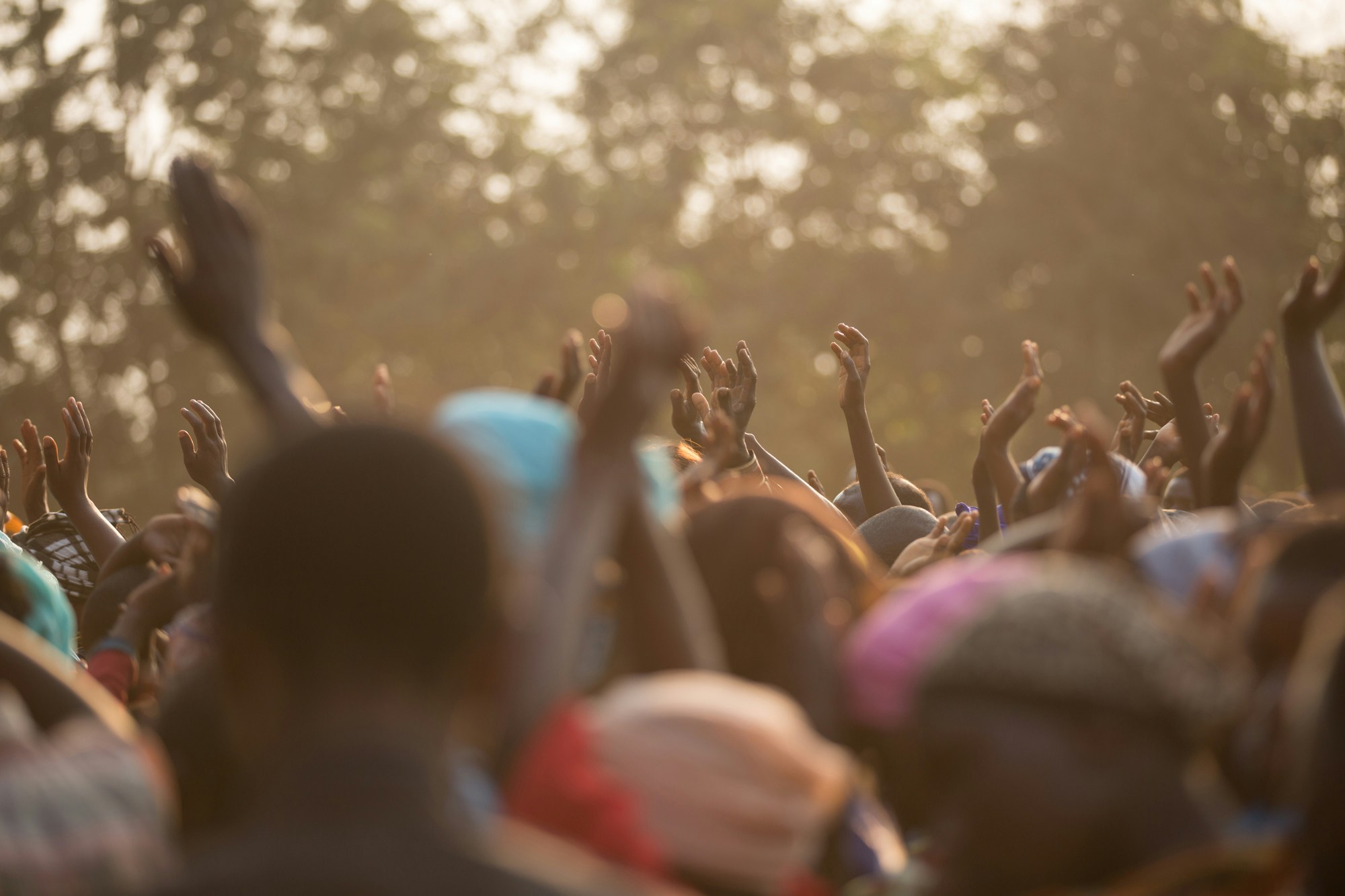 Congregation with hands raised during worship