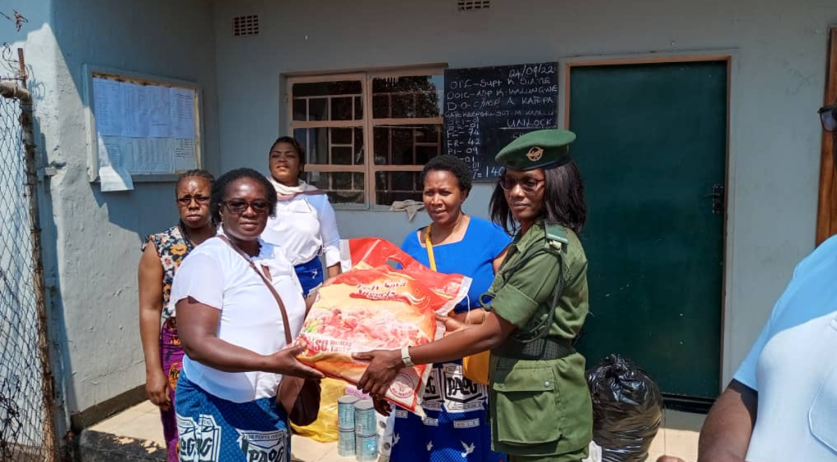 Church members handing over welfare supplies