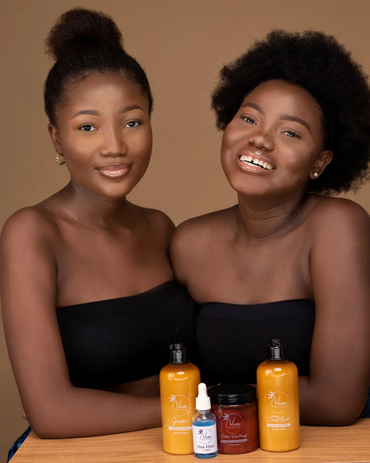 Two women holding skincare products