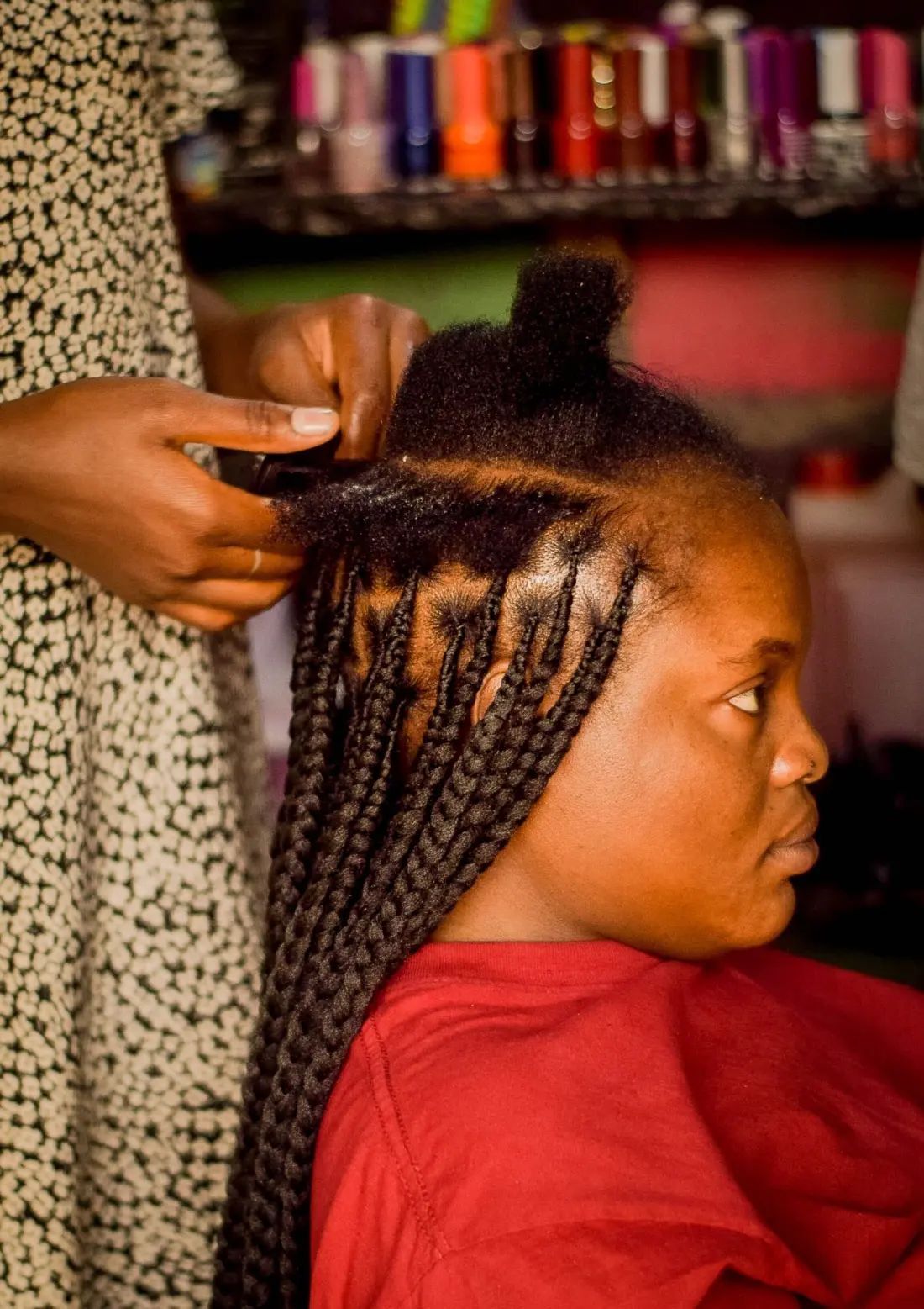 Stylist braiding a client's hair